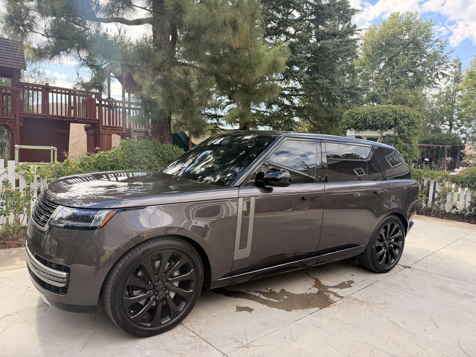Grey Range Rover with deep tinted windows parked at a residence