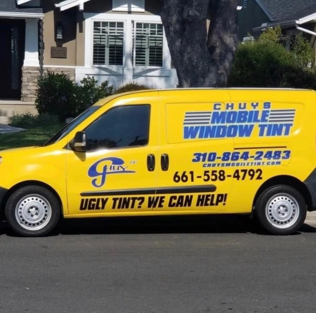 Chuy's Mobile Window Tint branded yellow service van parked in a neighborhood